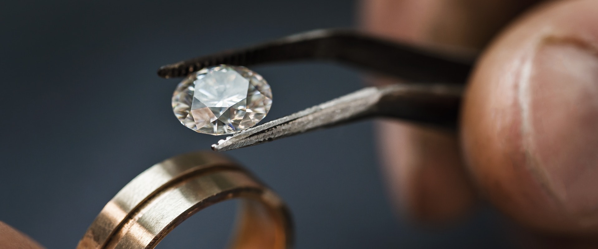Juwelier wählt einen Edelstein für einen zukünftigen Goldring aus, Nahaufnahme