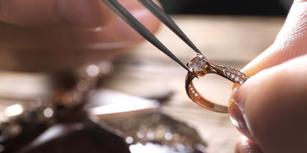 Männlicher Juwelier prüft Diamantring in Werkstatt, Nahaufnahme